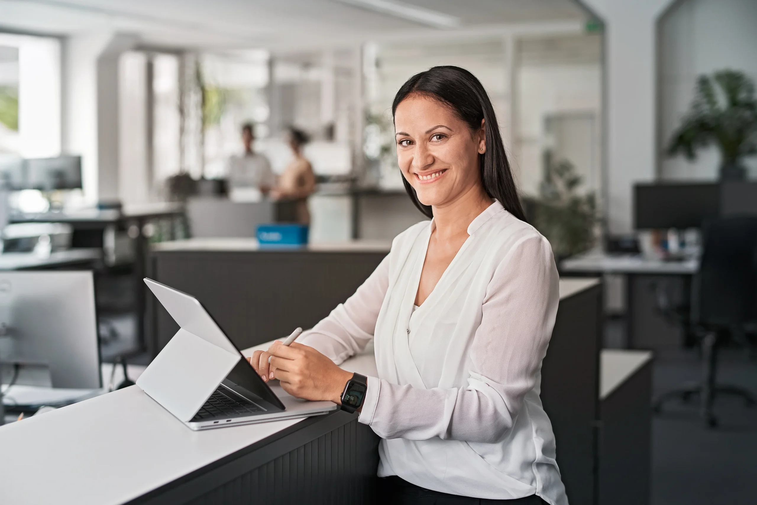 Woman with glasses in front of a group of people